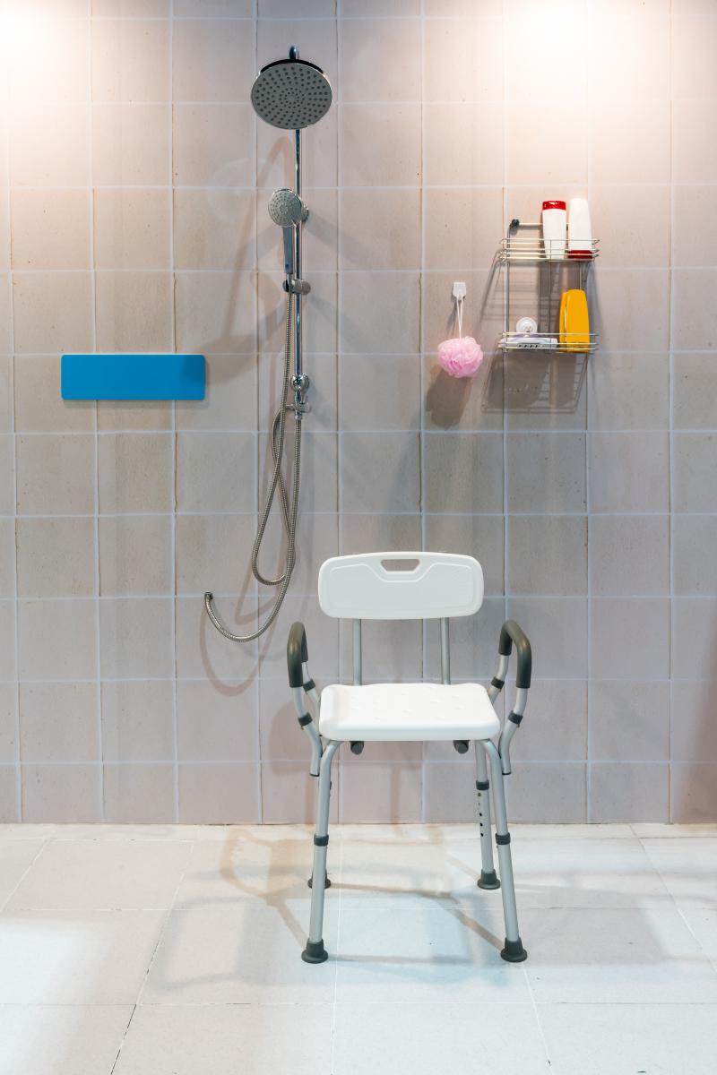 Shower chair positioned in accessible shower recess