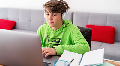 Boy with ADHD in front of computer with tutor