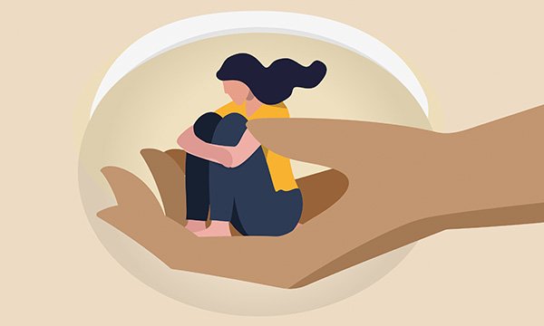 Girl sitting hugging her knees