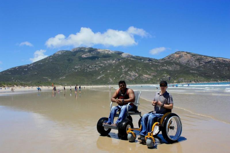 2 people in beach wheelchairs