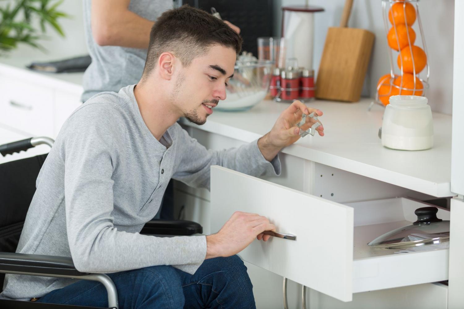 Person in a wheelchair opening a drawer