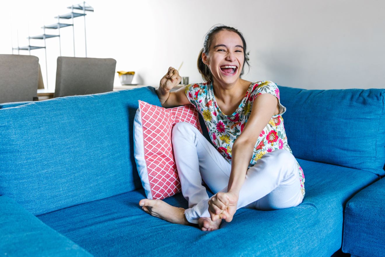 Woman with cerebral palsy seated on blue couch