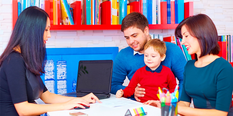 Parents sitting with their son at the desk of a therapist