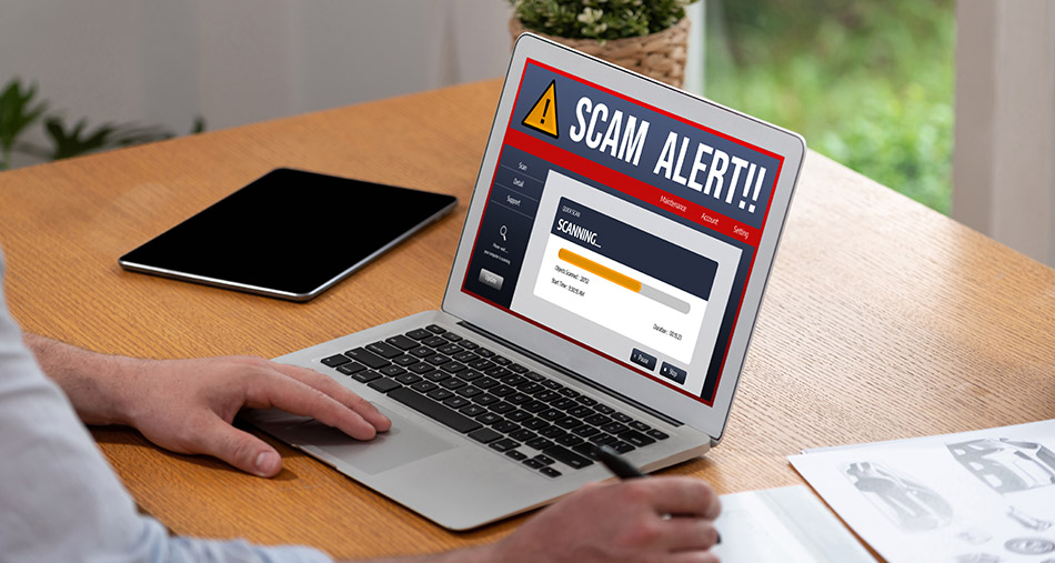 Laptop with a screen that says Scam Alert!