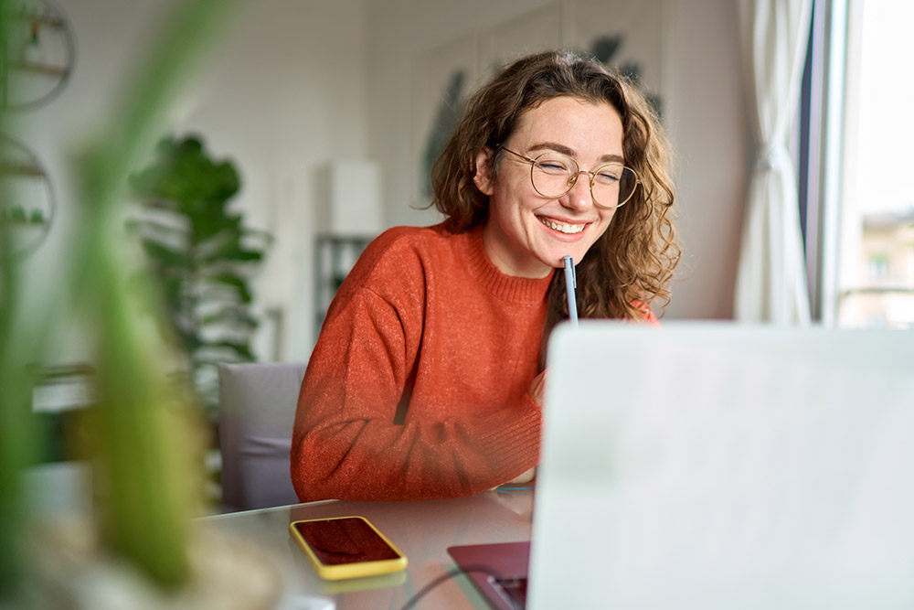 happy young woman taking part in online therapy session