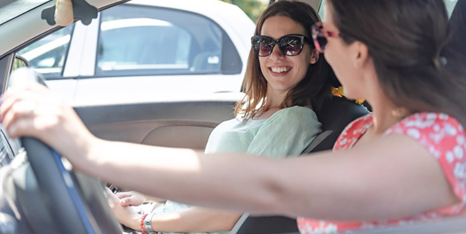 support worker with a participant in a car
