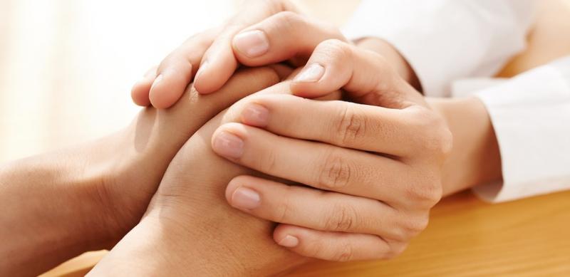 two hands clasped in embrace