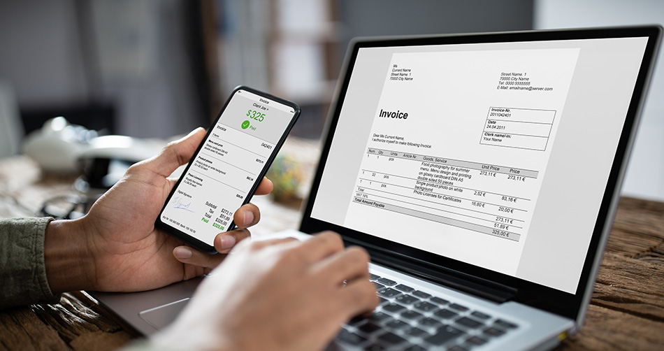 Person creating invoices on a laptop