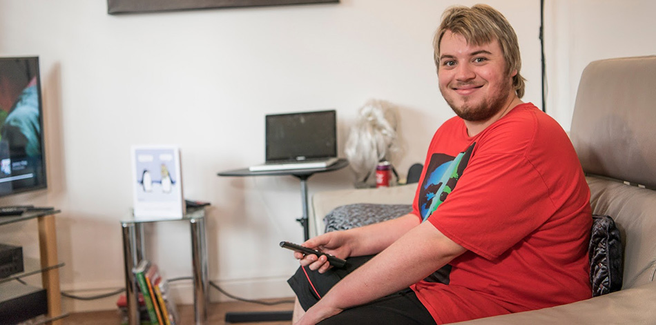 Young man sitting watching tv