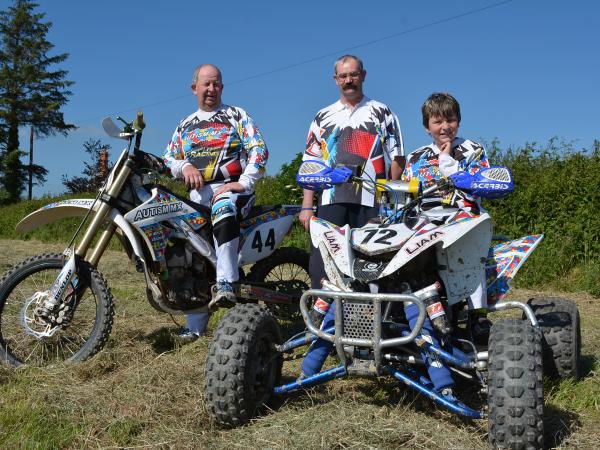 Liam sits on his quad bike smiling