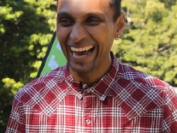 Omar in a red shirt laughing